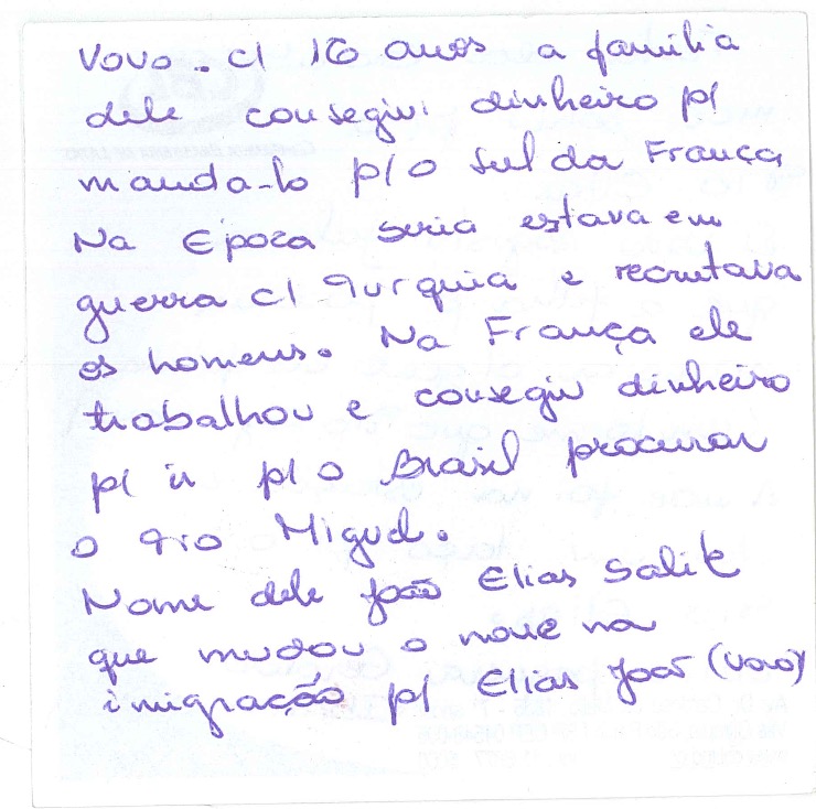 Standalone scan of a handwritten Portuguese note (purple ink) recording the story of João Elias's arrival from Syria. Same content appears as a page inside the larger Familia Elias PDF (artifact spring-scale); this is the page-level individual scan for inline embedding. Translation: "Vô at 16 years old, his family raised money to send him to the south of France. At the time Syria was at war with Turkey and conscripting men. In France he worked and raised money to go to Brazil to find his Tio Miguel. His name was Elias Salit which he changed during immigration to Elias João (Vô)."